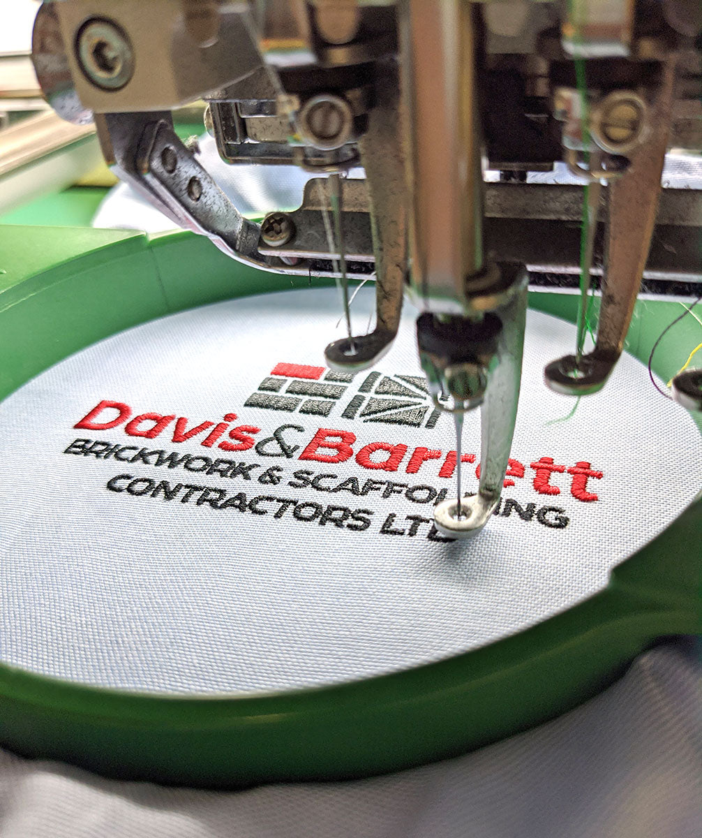 Embroidery machine stitching a corporate logo